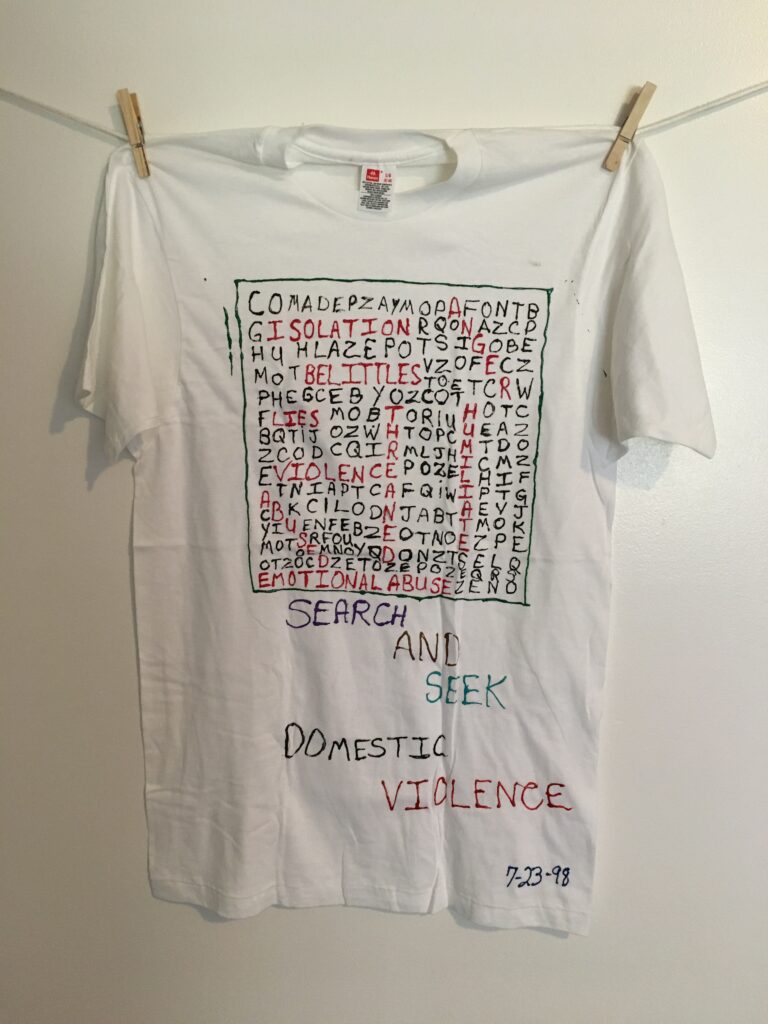 (pic of scrambled letters puzzle with the words ANGER, ISOLATION, BELITTLES, LIES, VIOLENCE, THREATENED, HUMILATE, ABUSED, and EMOTIONAL ABUSE highlighted in red.) SEARCH AND SEEK DOMESTIC VIOLENCE